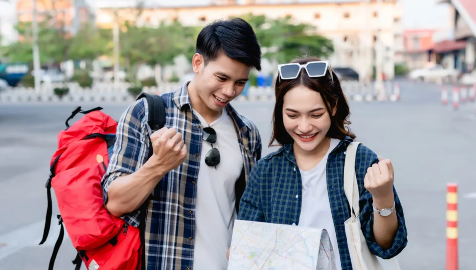 happy-asian-couple-tourist-backpackers-holding-paper-map-looking-direction-while-traveling-they-smile-with-glad-when-arrived-location-paper-map-destination